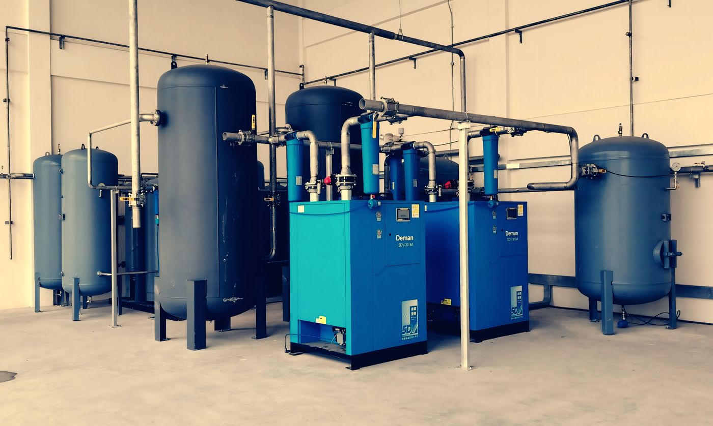 Rotary screw air compressors and receiver tanks in a plant